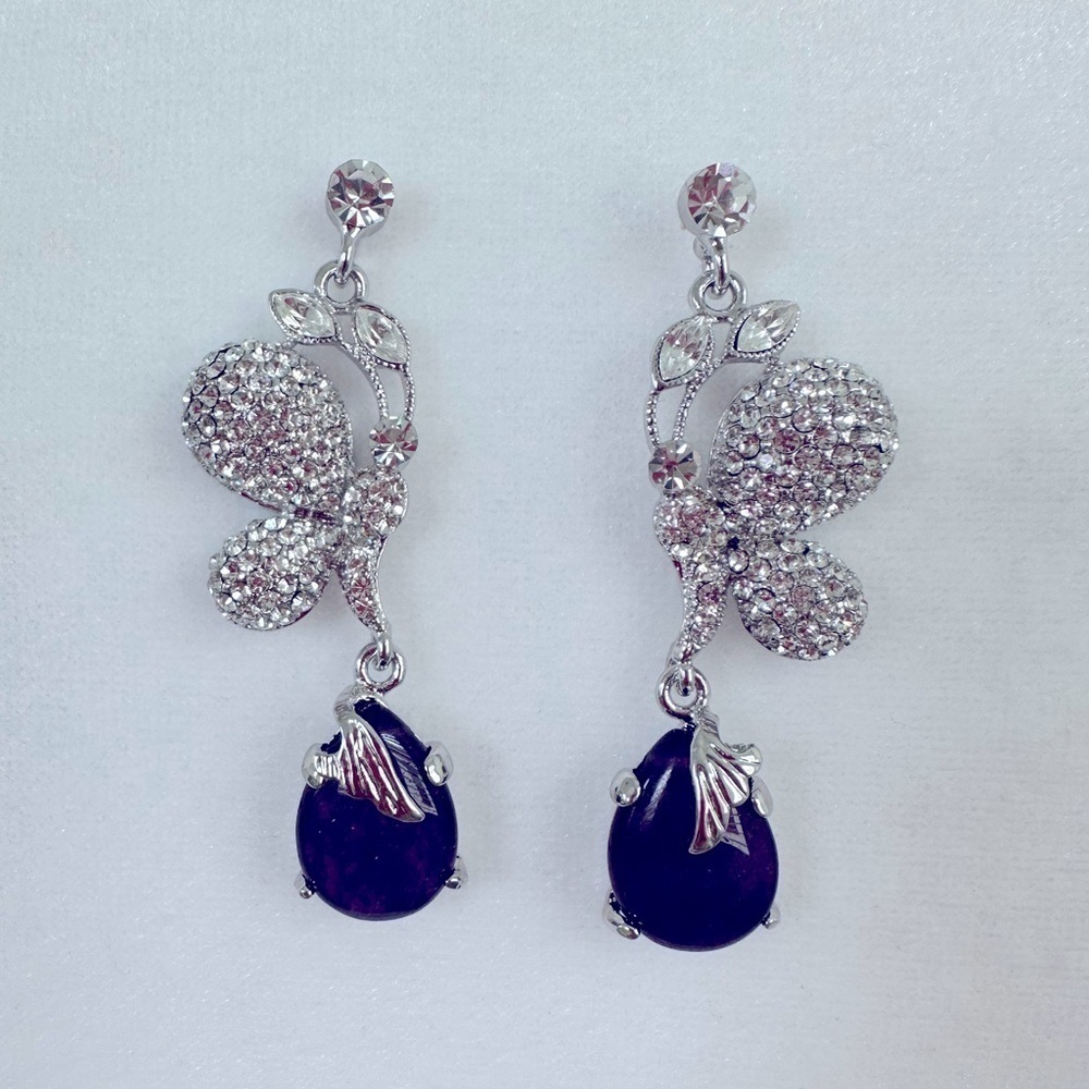 Drop Earrings encrusted with rhinestones and an amethyst colored stone.